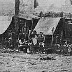 Soldiers in a camp writing letters